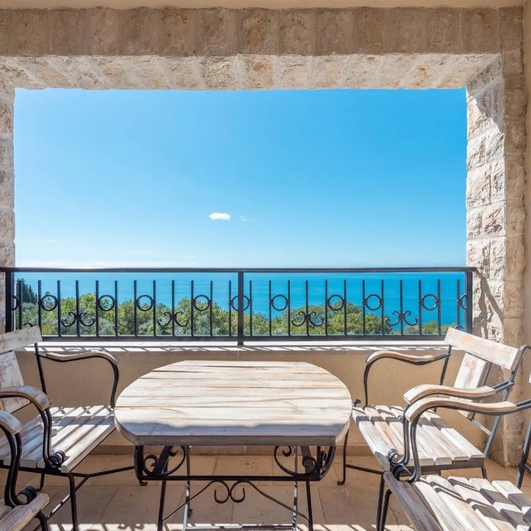 A complex of 6 villas with a swimming pool with an open sea view